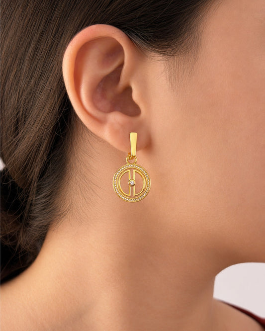 Woman wearing gold vermeil moon drop earrings, showing the pendant size and elegant celestial design when worn.