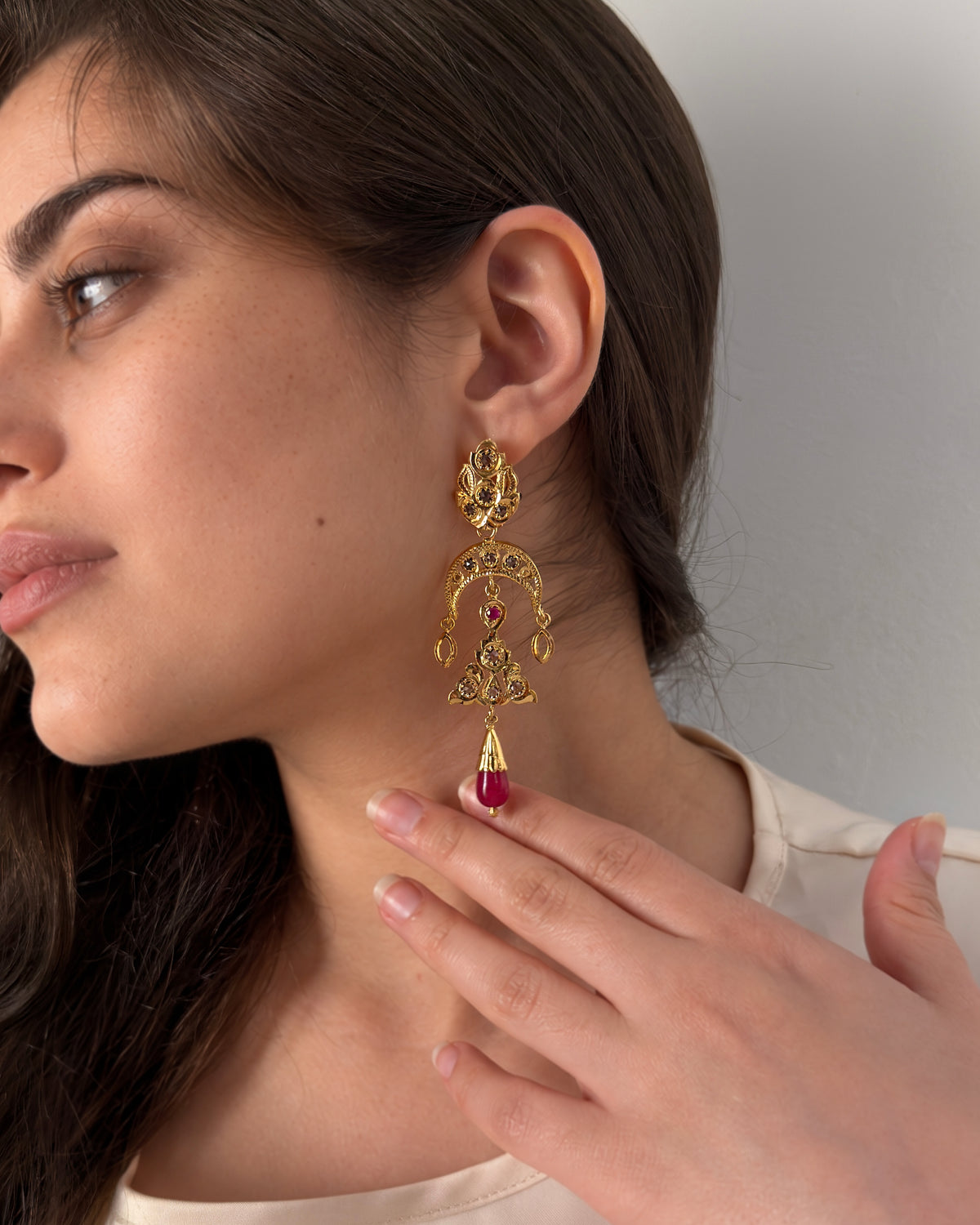 Moroccan statement earring in gold-plated 925 sterling silver with red cabochon worn on model