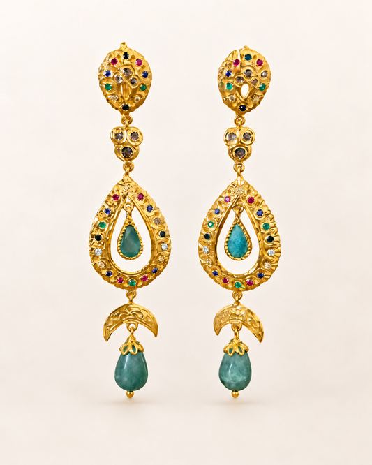 Pair of Moroccan sterling silver drop earrings with gold plating, multicoloured stones and green cabochons on an ivory background.