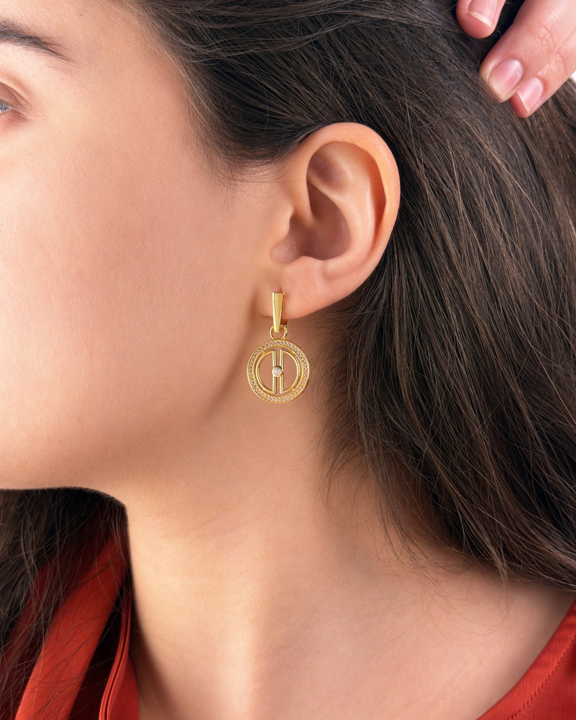 Lifestyle photo of gold vermeil moon drop earrings worn on the ear, highlighting the polished finish and refined everyday styling.