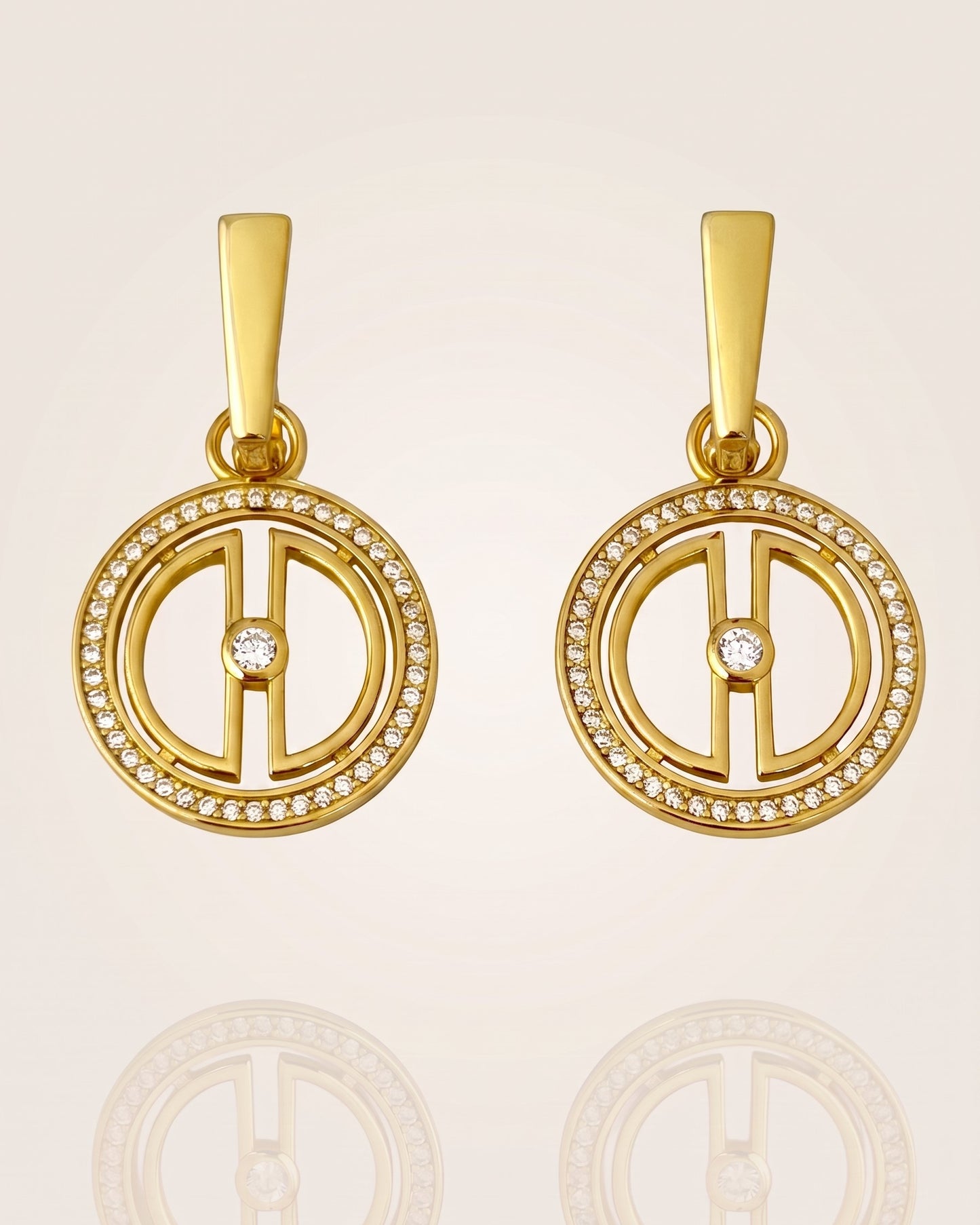 Pair of convertible gold moon earrings in 18K gold vermeil with cubic zirconia details, displayed on a soft neutral background with subtle reflection.