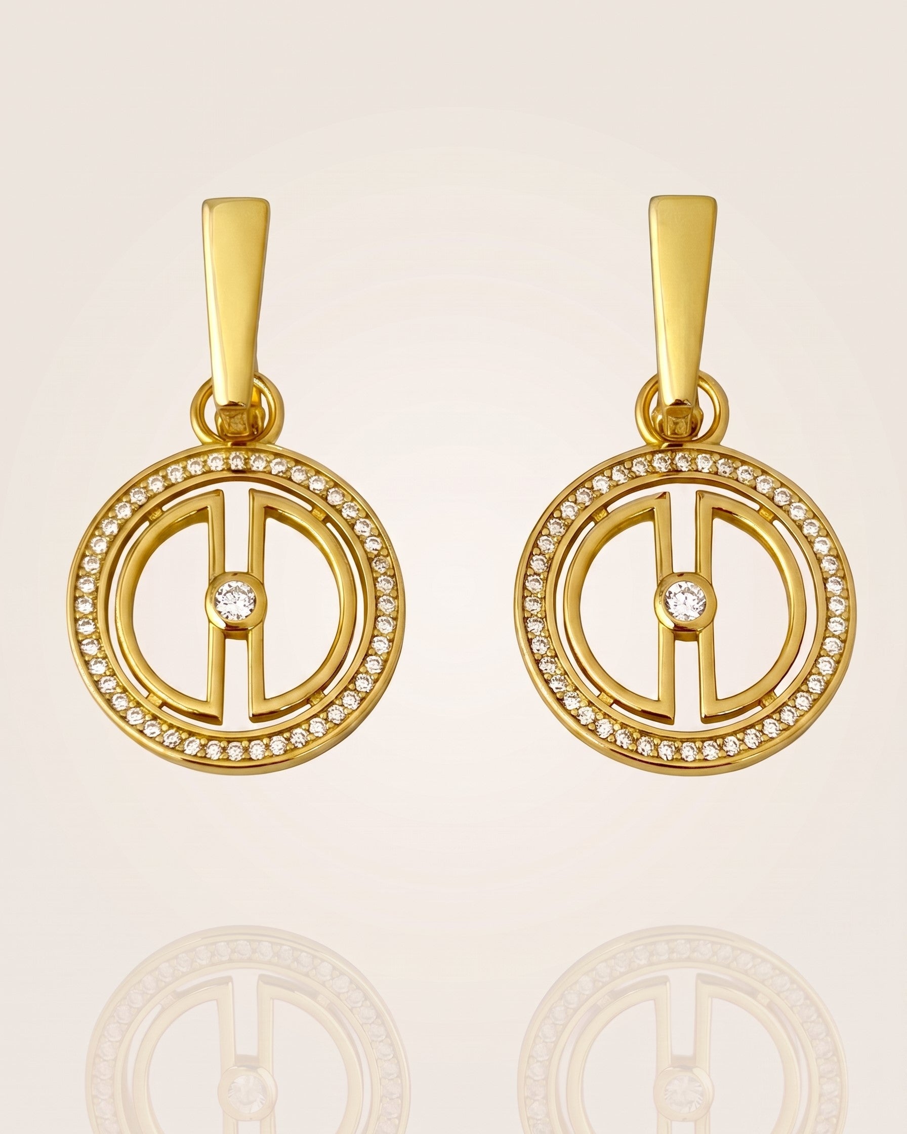 Pair of convertible gold moon earrings in 18K gold vermeil with cubic zirconia details, displayed on a soft neutral background with subtle reflection.