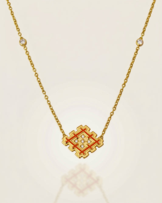 Orange enamel Lion’s Paw pendant necklace in gold vermeil with cubic zirconia details, displayed on a soft neutral background with subtle reflection.